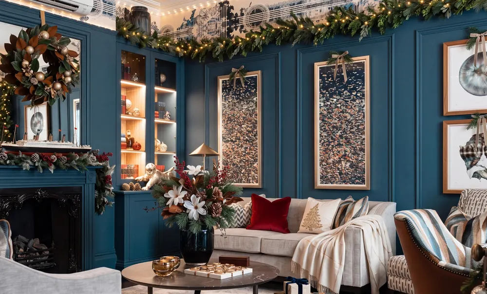 A fireplace and lounge dressed with a wreath and garlands