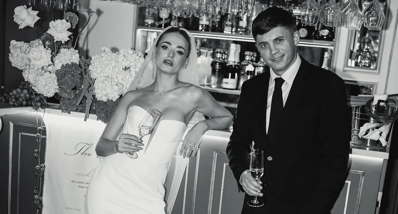 A couple with Champagne at the bar in Nocturne, in black and white