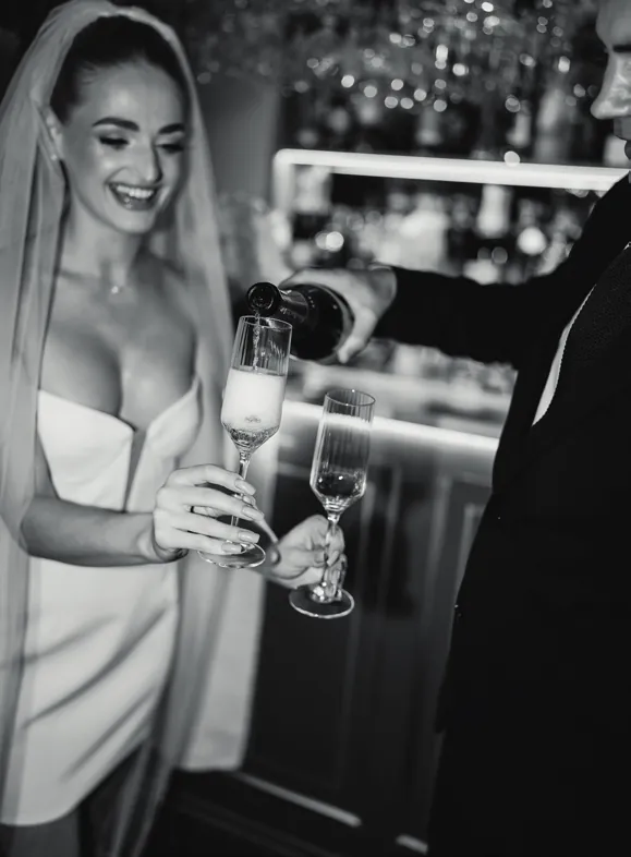 Champagne being poured into a flute at the bar in Nocturne