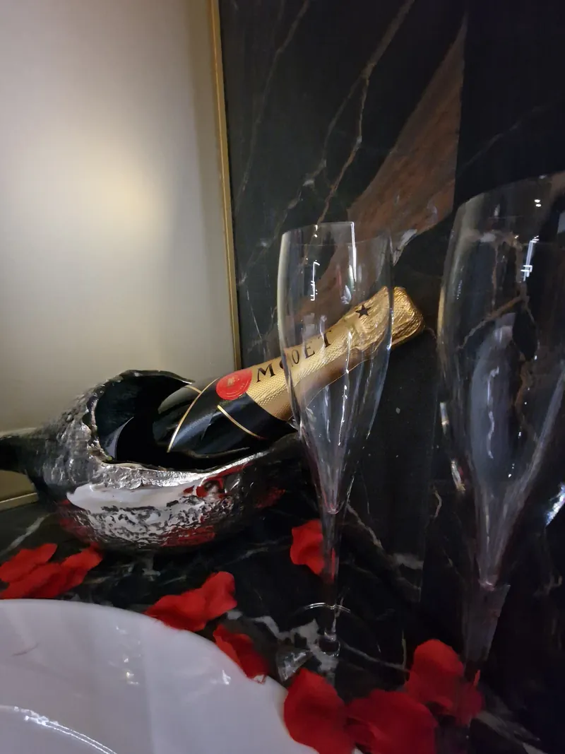 Champagne on ice with rose petals